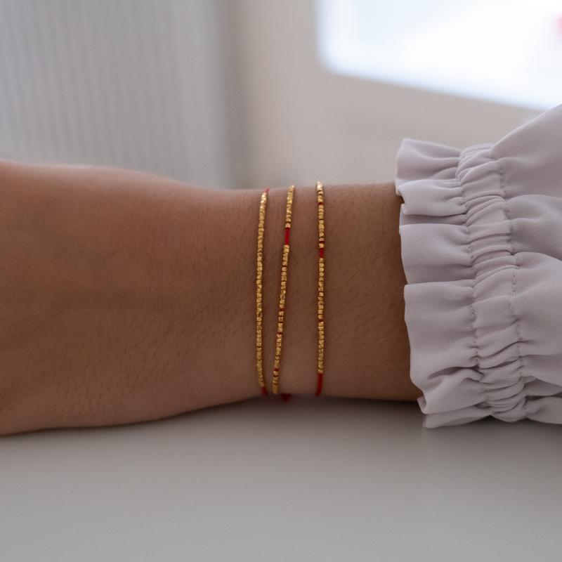 Delicate gold bracelet  with silk cord
