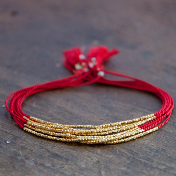 Red bracelet with shop gold