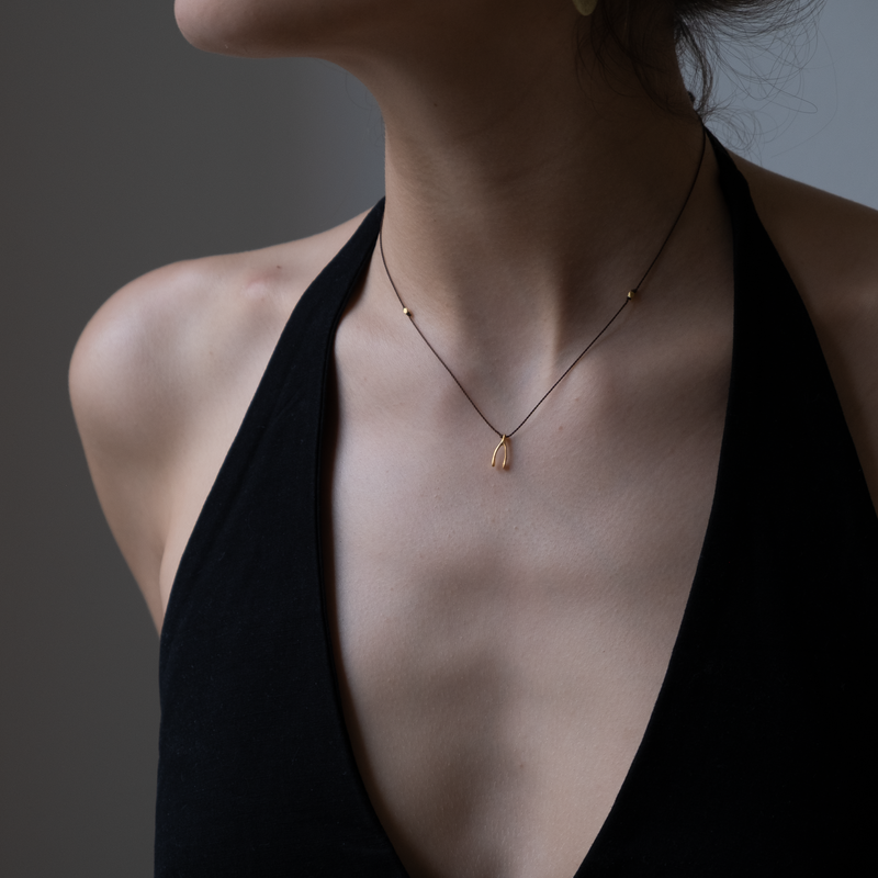 14k gold Wishbone Charm necklace on silk