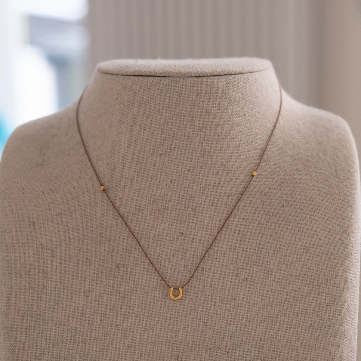 14k gold Horseshoe Charm necklace on silk